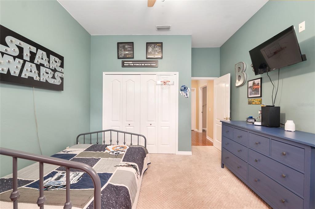 9350 Southwest 46 Place Gainesville, FL 32608 - Photo 42 of 63 a bedroom with a bed and a flat screen tv