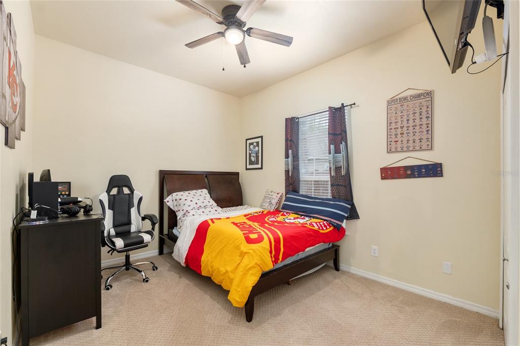 9350 Southwest 46 Place Gainesville, FL 32608 - Photo 45 of 63 a bedroom with a bed and lamp