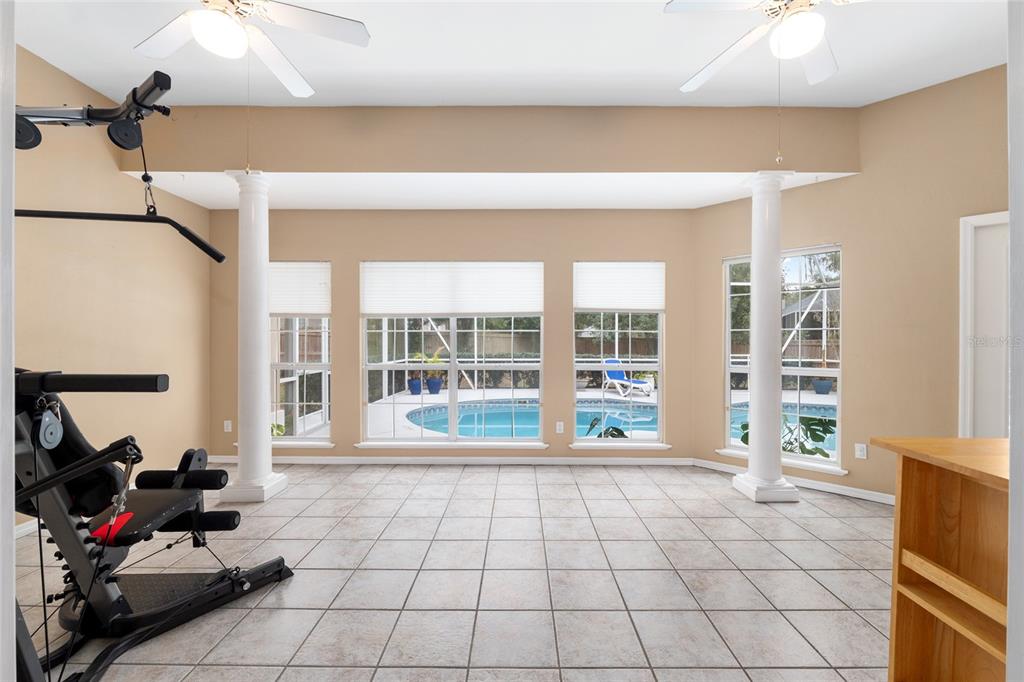 9350 Southwest 46 Place Gainesville, FL 32608 - Photo 52 of 63 a living room with furniture and a floor to ceiling window
