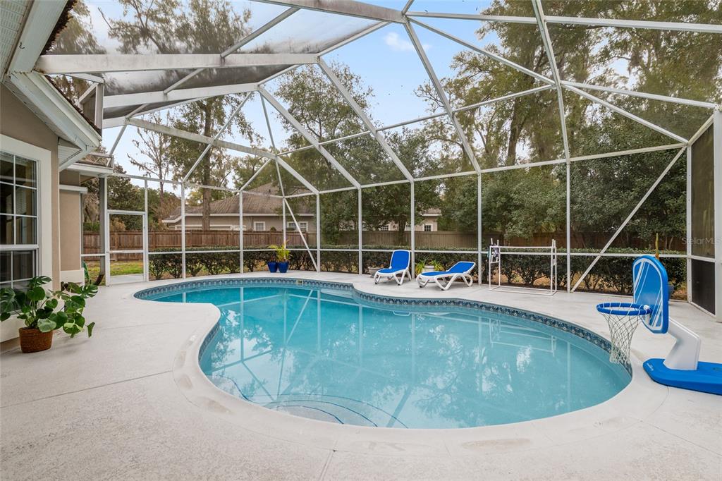 9350 Southwest 46 Place Gainesville, FL 32608 - Photo 54 of 63 a view of a swimming pool with a glass door