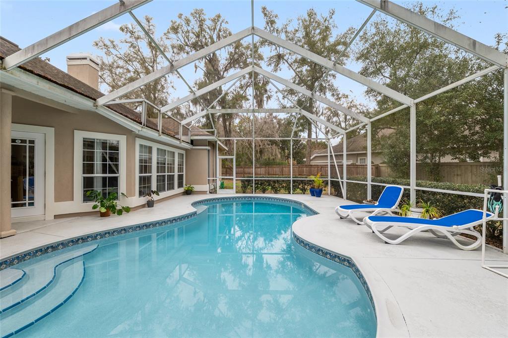9350 Southwest 46 Place Gainesville, FL 32608 - Photo 56 of 63 a view of a swimming pool with a patio and a yard