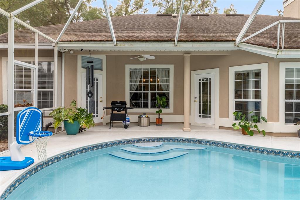 9350 Southwest 46 Place Gainesville, FL 32608 - Photo 57 of 63 a front view of a house with swimming pool and porch