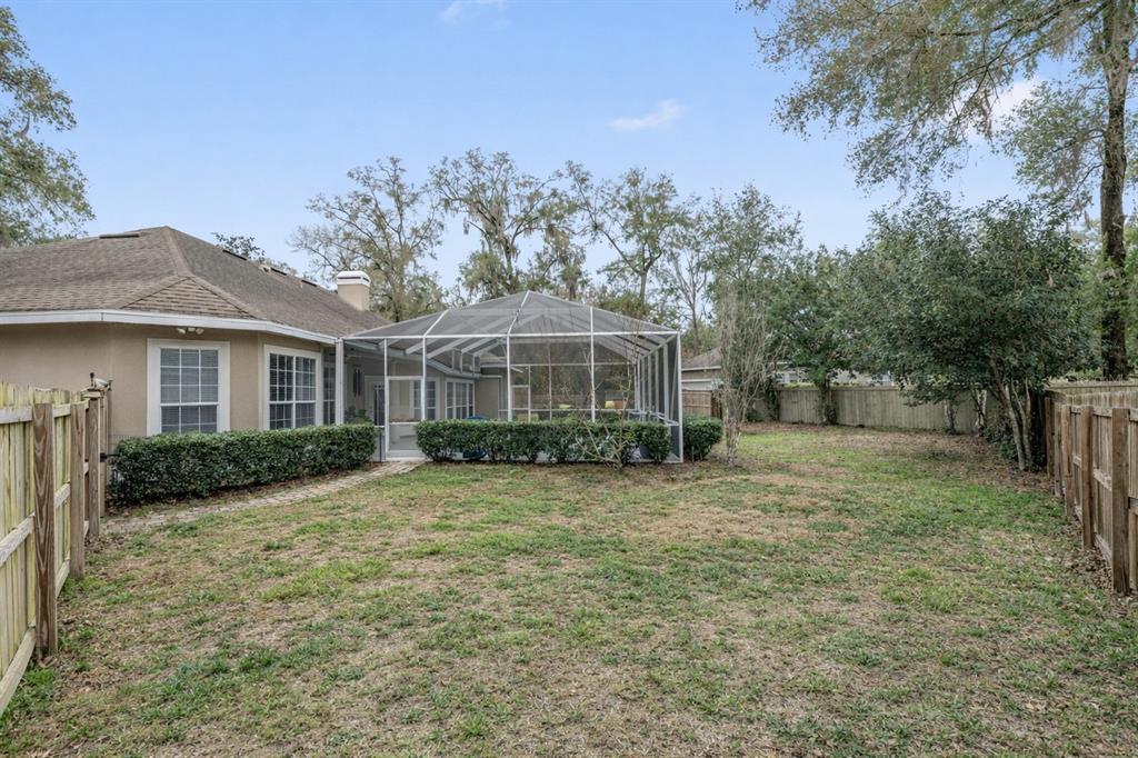 9350 Southwest 46 Place Gainesville, FL 32608 - Photo 62 of 63 a front view of a house with a yard