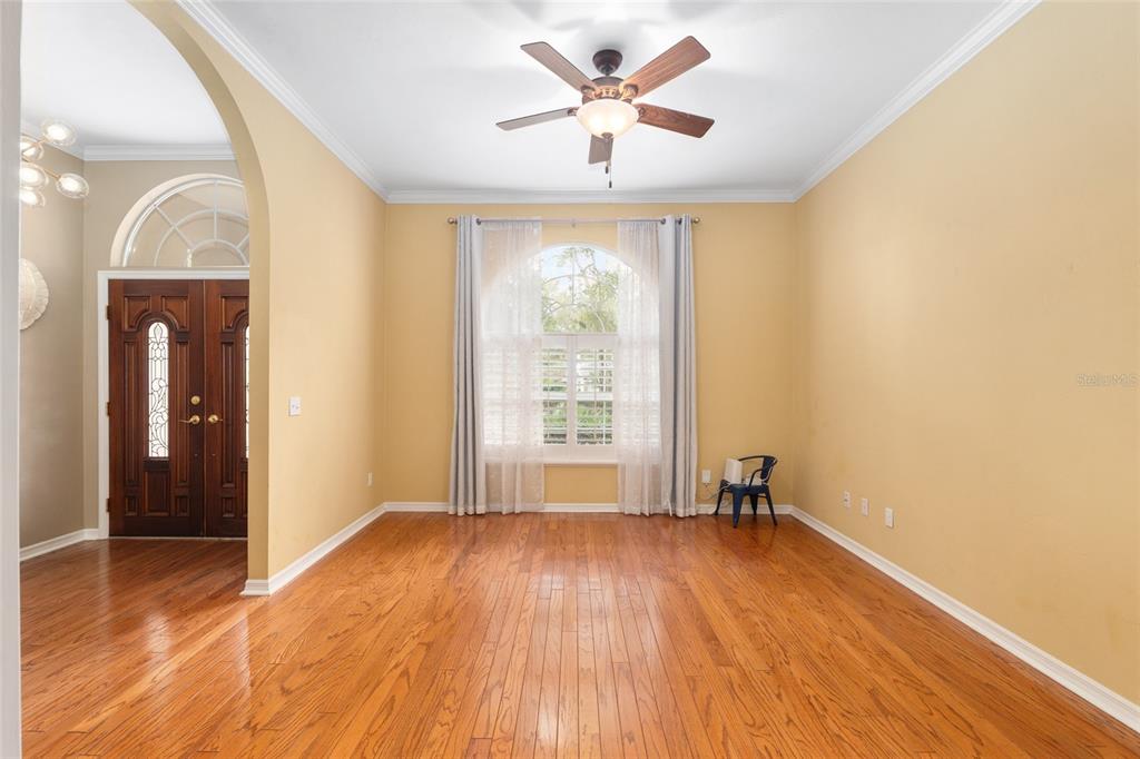 9350 Southwest 46 Place Gainesville, FL 32608 - Photo 8 of 63 a view of empty room with wooden floor and fan