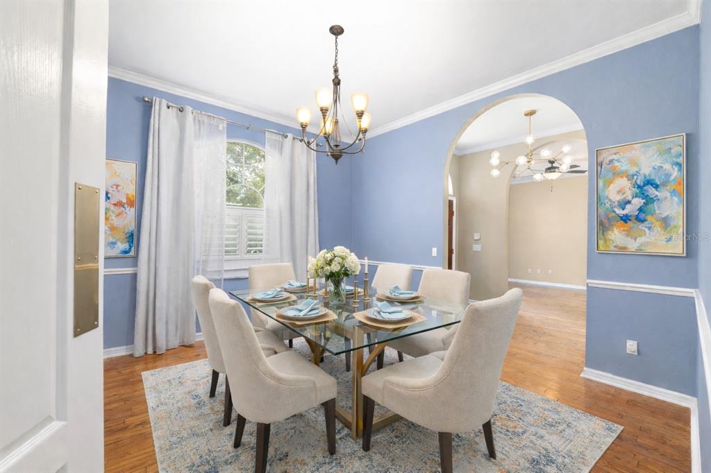 9350 Southwest 46 Place Gainesville, FL 32608 - Photo 9 of 63 a view of a dining room with furniture window and wooden floor