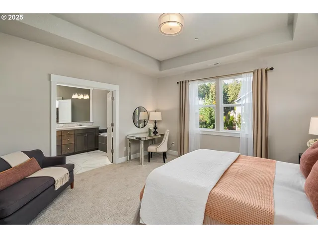 a bedroom with a large bed mirror and a window
