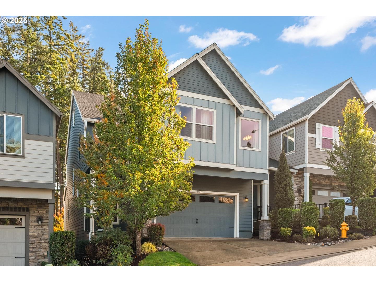 8144 Southwest Oldham Drive Beaverton, OR 97007 - Photo 2 of 33 a front view of a house with a yard and garage