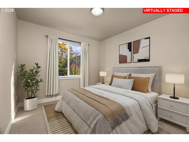 a bedroom with a large bed and a potted plant