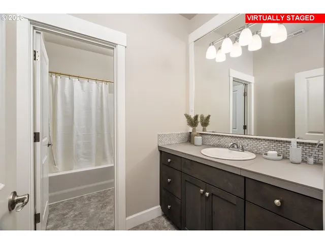 a bathroom with a sink vanity and a mirror