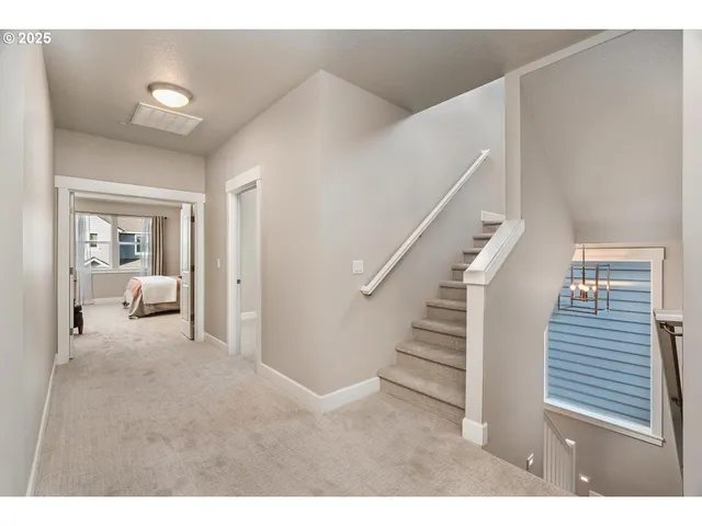 a view of a livingroom with white walls and stairs