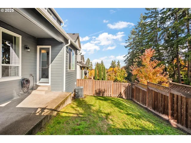 a view of a backyard with wooden fence