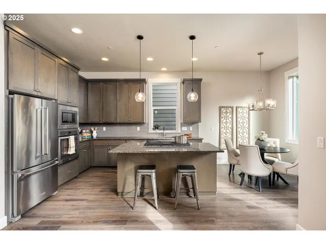 a large kitchen with a table and chairs