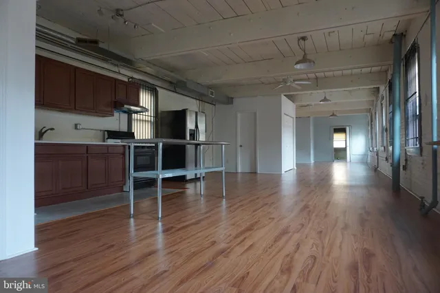 a view of a room with wooden floors and lots of wooden cabinets