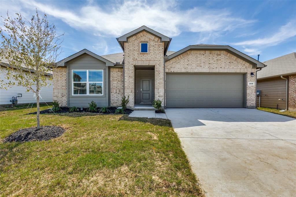 269 Cal Frd Drive Justin, TX 76247 - Photo 1 of 1 View of front of house featuring brick siding, concrete driveway, an attached garage, and a front lawn