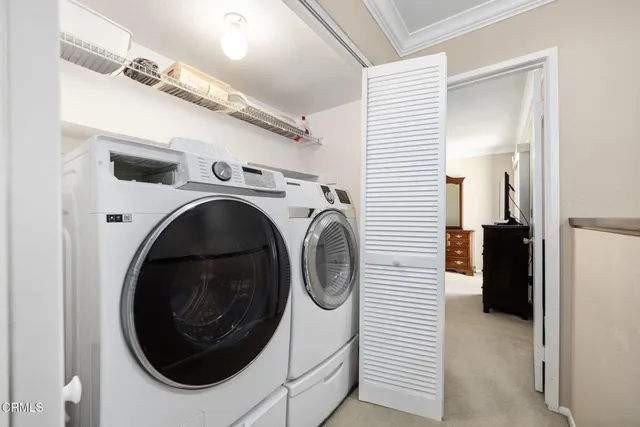 a view of a patio with a table and chairs under an umbrella