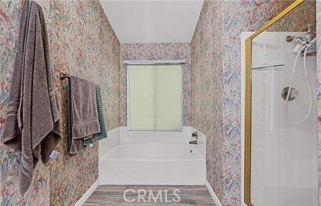 2906 Summer Set Circle Banning, CA 92220 - Photo 18 of 38 a bathroom with a bathtub and a shower