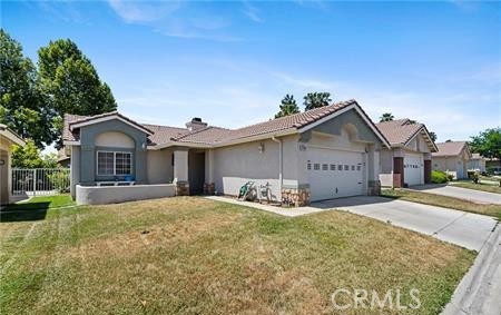 2906 Summer Set Circle Banning, CA 92220 - Photo 2 of 38 a front view of a house with a yard and garage