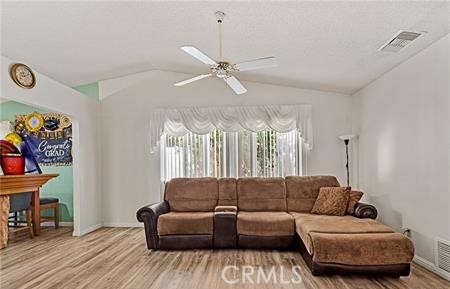 2906 Summer Set Circle Banning, CA 92220 - Photo 5 of 38 a living room with furniture a fireplace and a chandelier