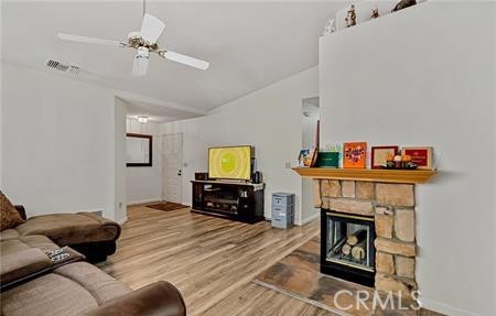 2906 Summer Set Circle Banning, CA 92220 - Photo 10 of 38 a living room with furniture and a fireplace with a bookshelf