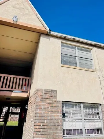 a view of a balcony with wooden floor and fence