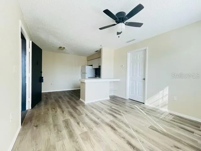 a view of a kitchen with a sink and a refrigerator