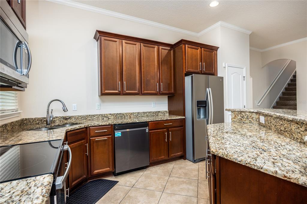 8216 Northwest 54th Street Gainesville, FL 32653 - Photo 29 of 58 a kitchen with stainless steel appliances granite countertop a sink stove and refrigerator