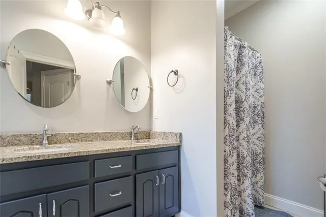 a bathroom with a tub sink and mirror