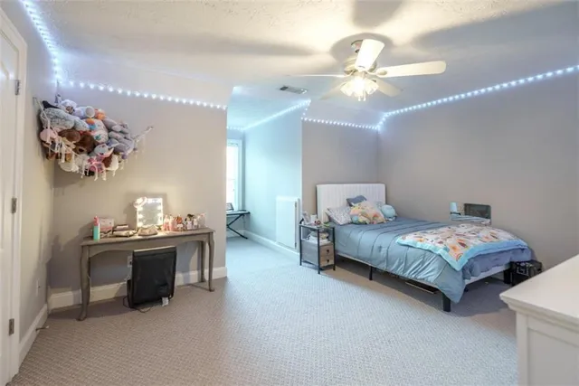 a spacious bedroom with a bed window and couch