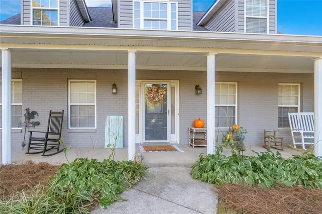 a view of a livingroom with wooden floor and a large window