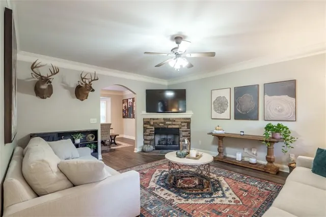 a living room with furniture a fireplace and a table