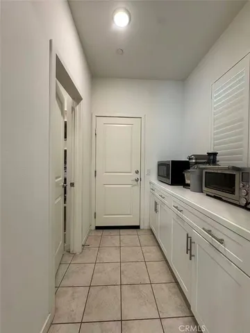 a kitchen with a refrigerator a stove and cabinets