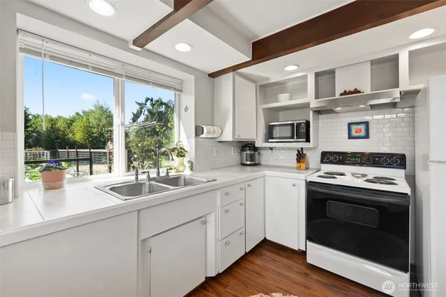a kitchen with a sink stove and cabinets