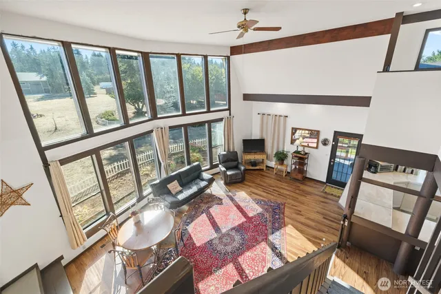 a living room with furniture and a floor to ceiling window