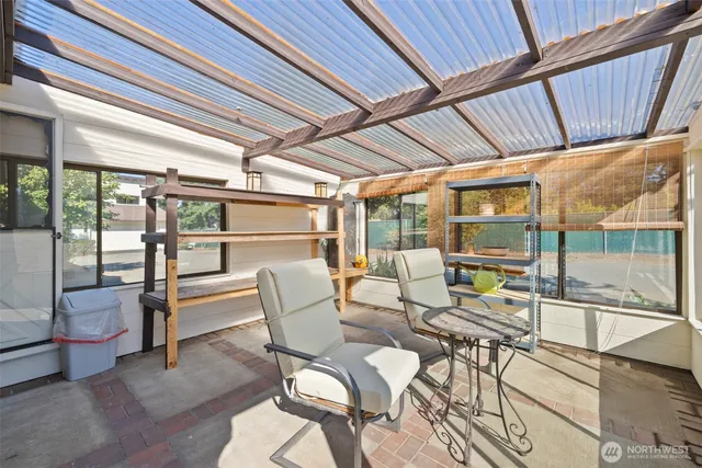 a outdoor space with a large window and furniture