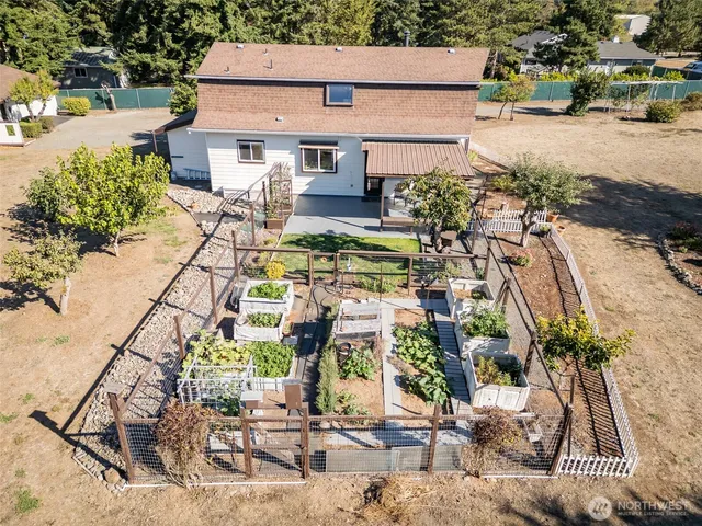 a aerial view of a house with a yard and potted plants