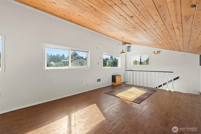 a view of a livingroom with wooden floor and white walls