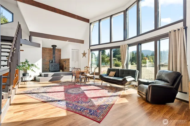a living room with furniture and floor to ceiling windows