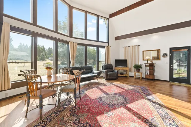 a living room with furniture tv and a large window