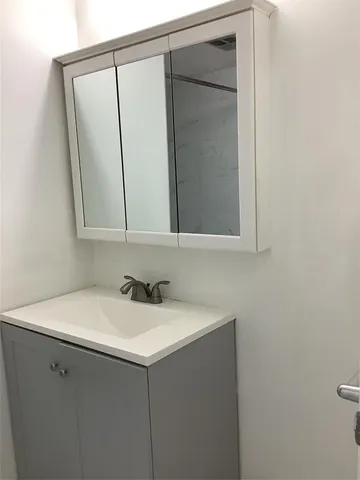 a view of a bathroom with mirror