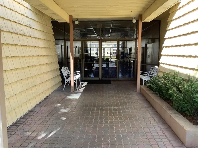 a dining room with furniture and a floor to ceiling window