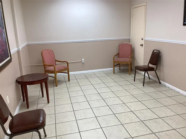 a view of hallway with a window and a kitchen