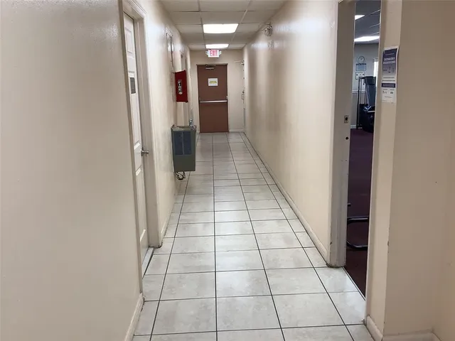 a dining room with furniture and a potted plant