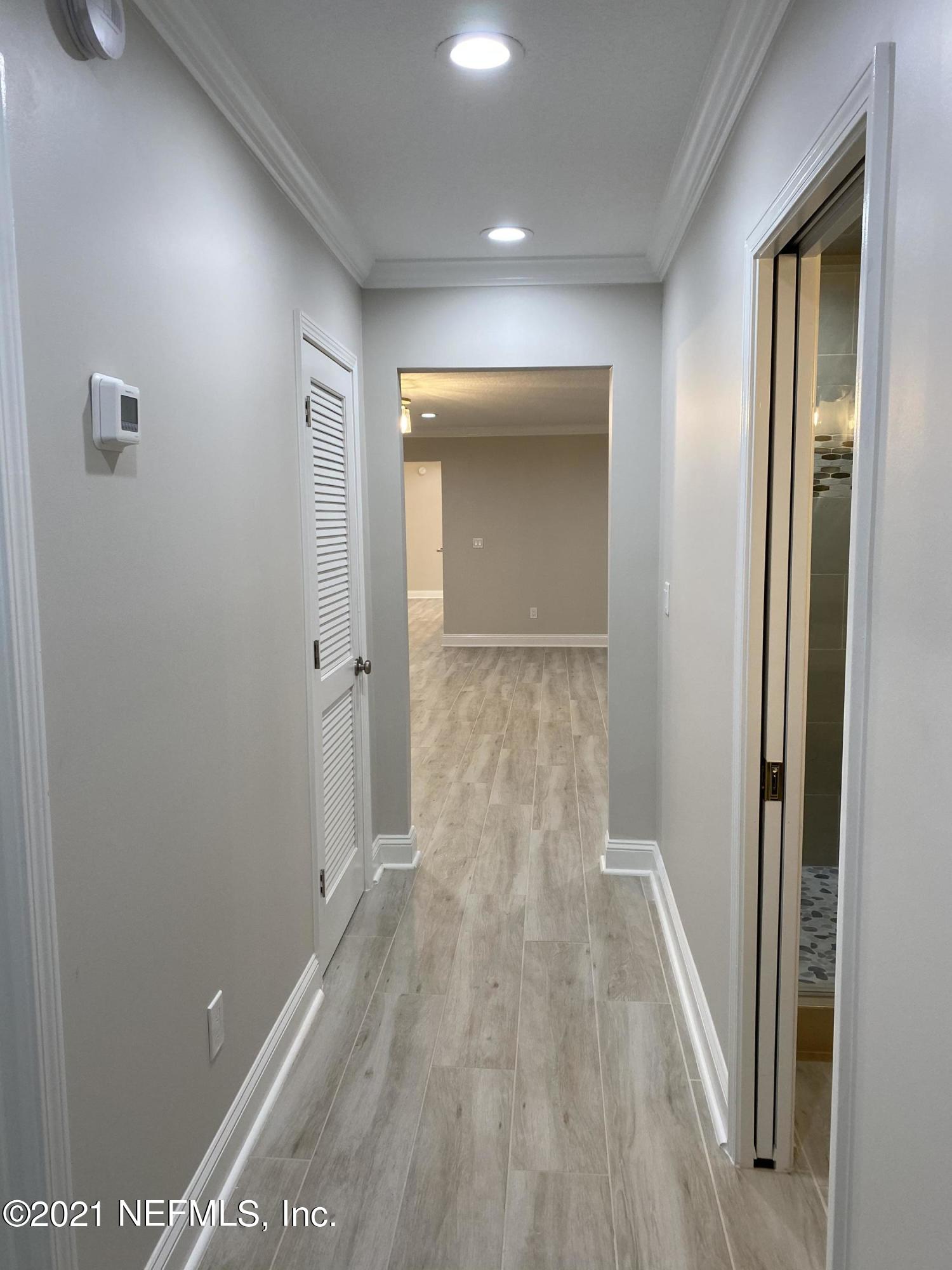 9709 Lily Road Jacksonville, FL 32246 - Photo 19 of 60 a view of a hallway with wooden floor