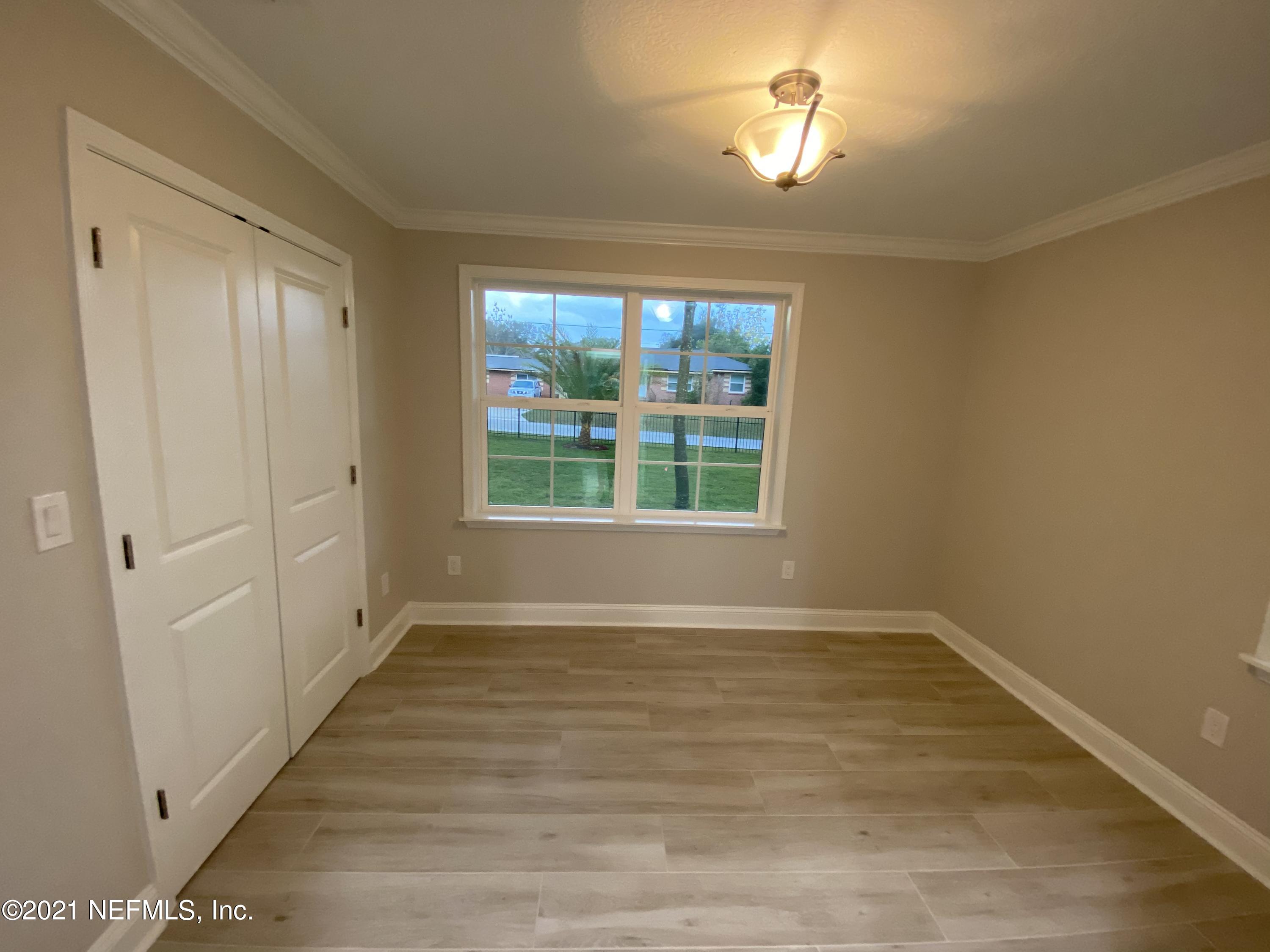 9709 Lily Road Jacksonville, FL 32246 - Photo 32 of 60 wooden floor in an empty room with a window