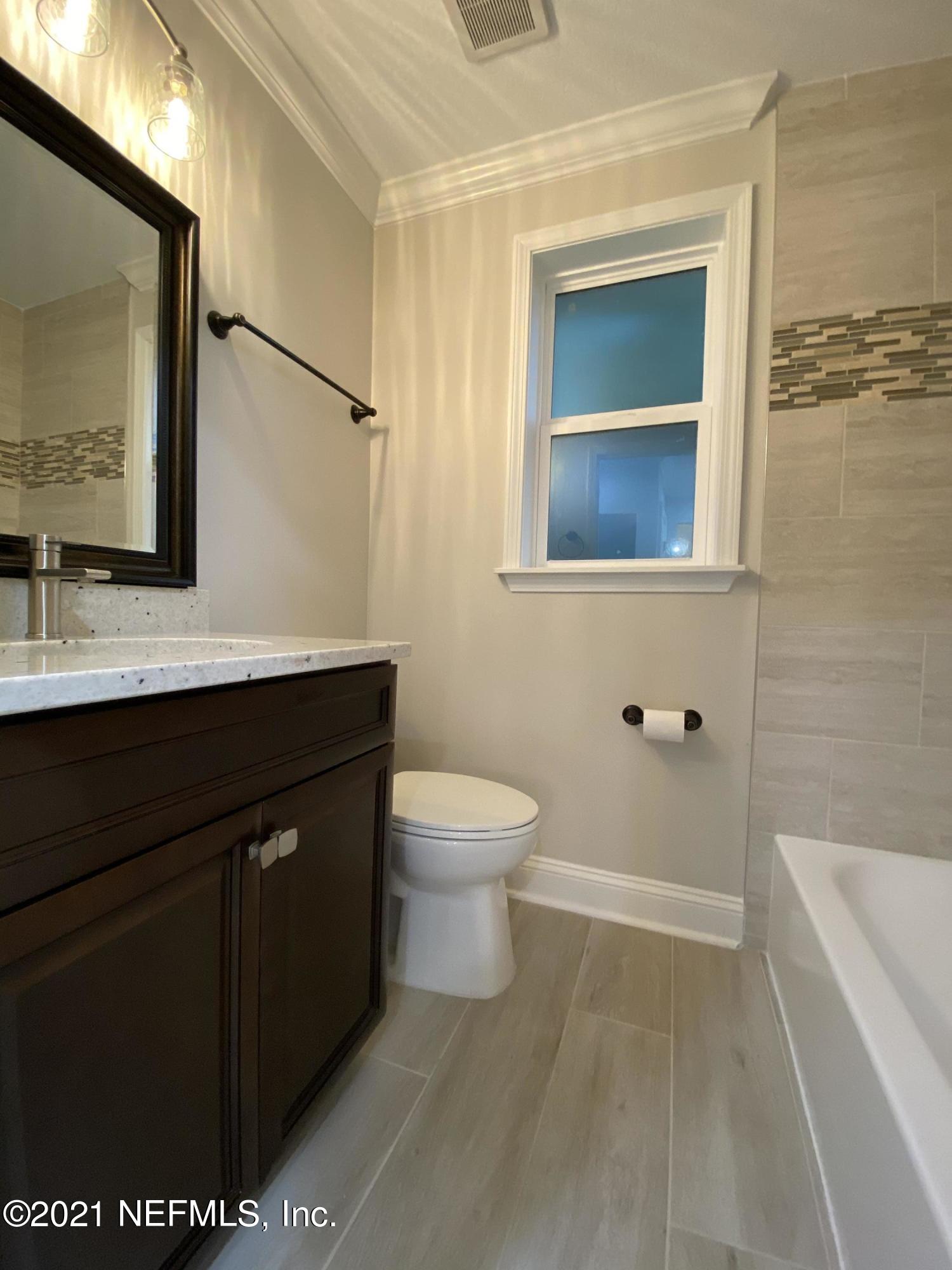 9709 Lily Road Jacksonville, FL 32246 - Photo 34 of 60 a bathroom with a granite countertop sink toilet and mirror