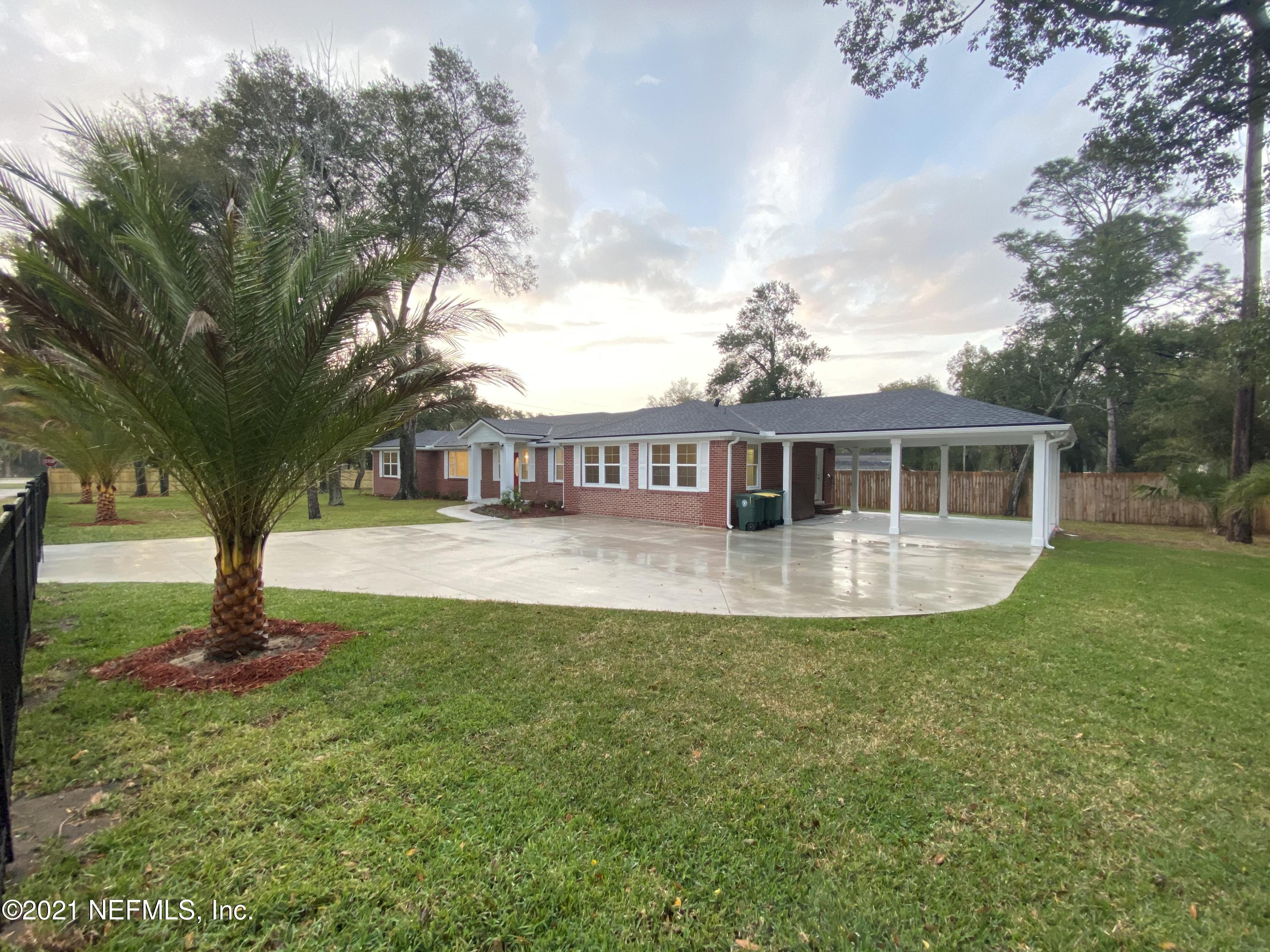 9709 Lily Road Jacksonville, FL 32246 - Photo 57 of 60 a front view of a house with a garden