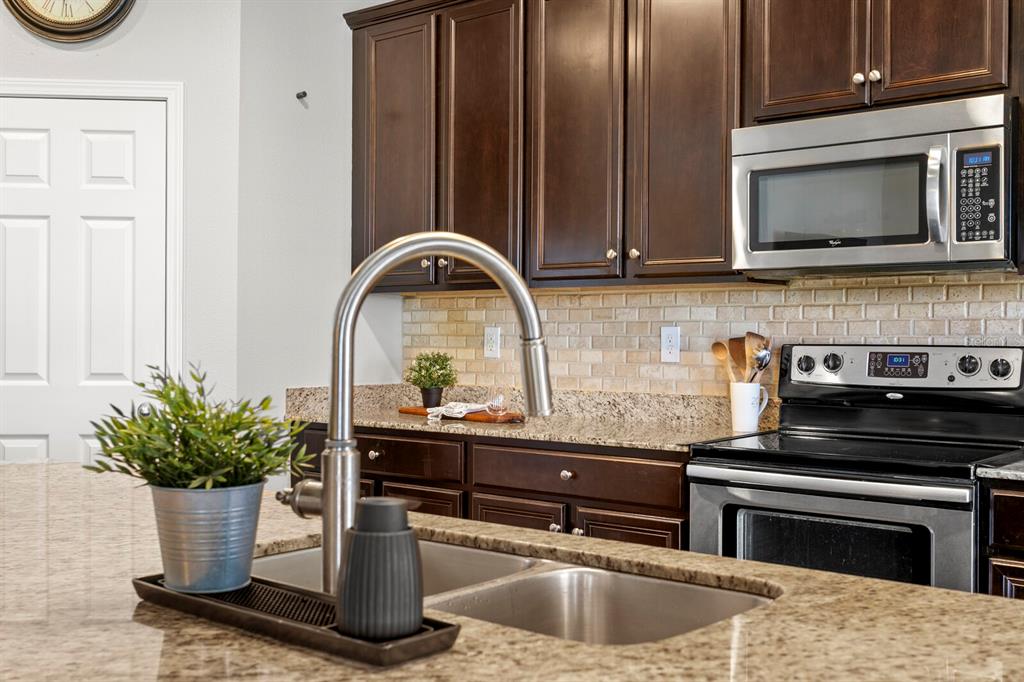 2839 Maple Brook Loop Lutz, FL 33558 - Photo 11 of 61 a kitchen with a stove and a sink