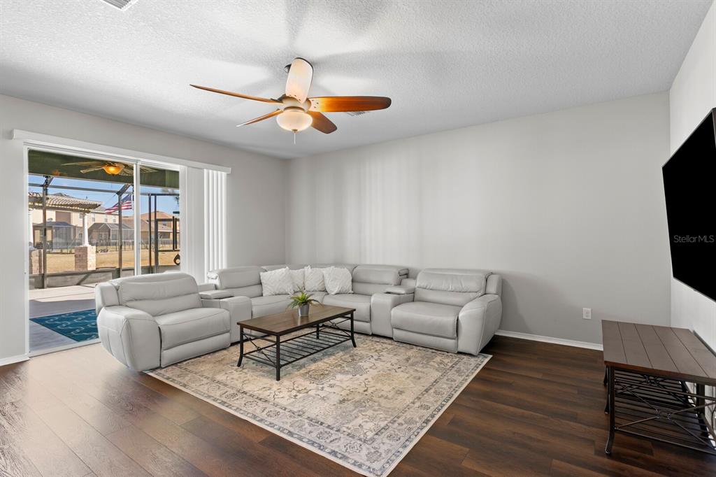 2839 Maple Brook Loop Lutz, FL 33558 - Photo 17 of 61 a living room with furniture and a flat screen tv