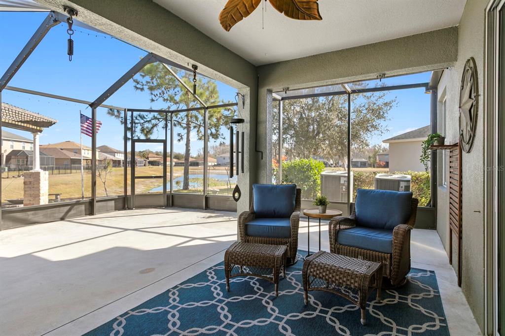 2839 Maple Brook Loop Lutz, FL 33558 - Photo 19 of 61 a living room with furniture and a large window