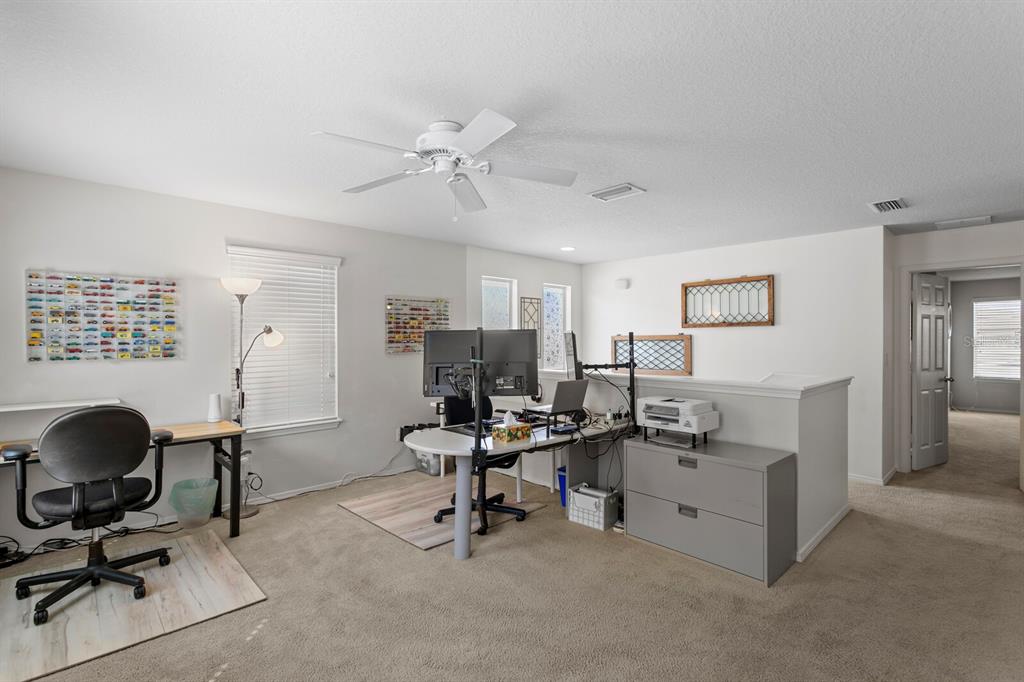2839 Maple Brook Loop Lutz, FL 33558 - Photo 26 of 61 a view of a workspace with furniture and a window